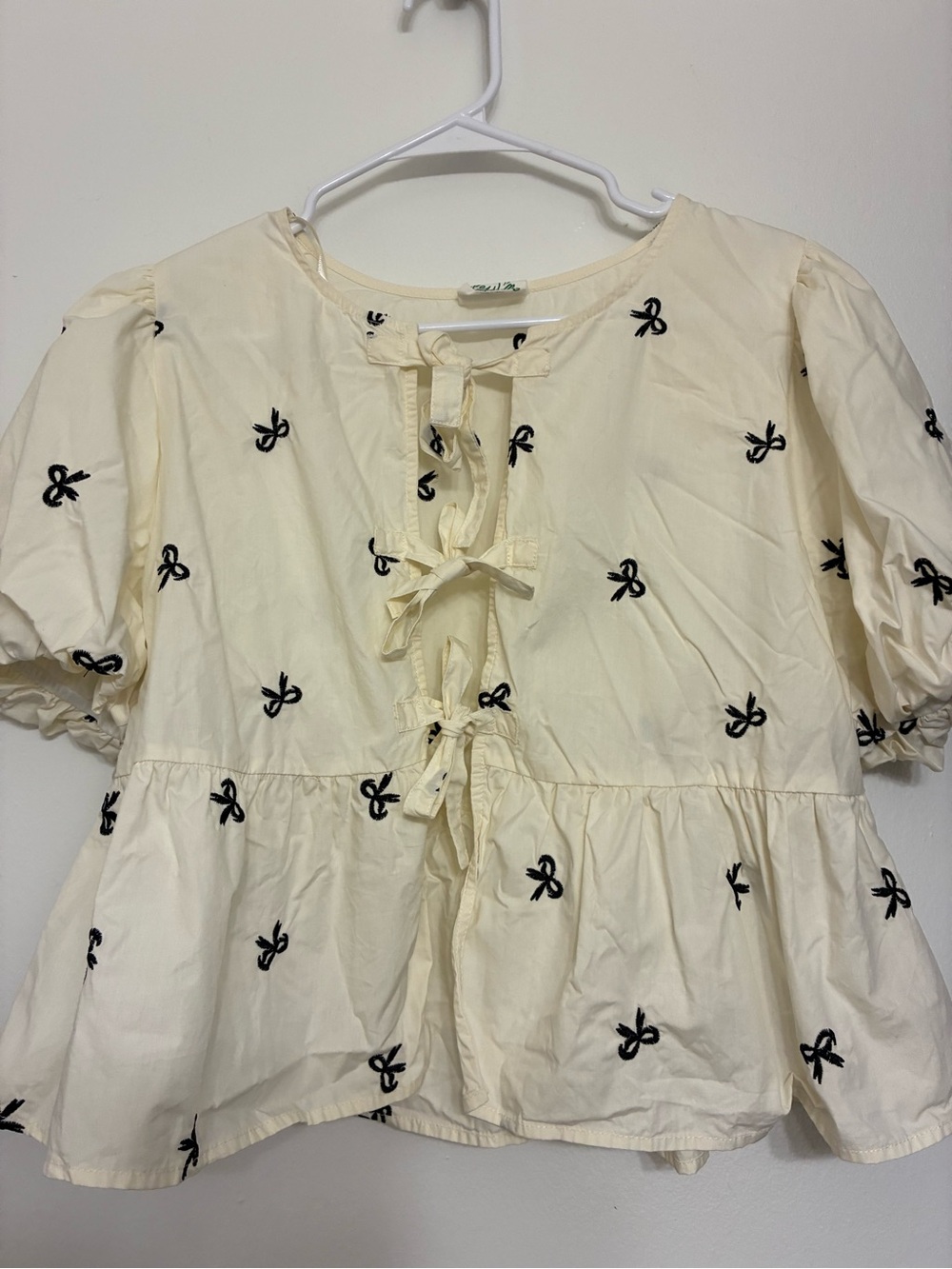 Cream Tie-Front Peplum Blouse with Black Bow Embroidery